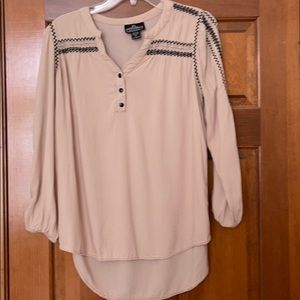 Angie tan with black smocking top.